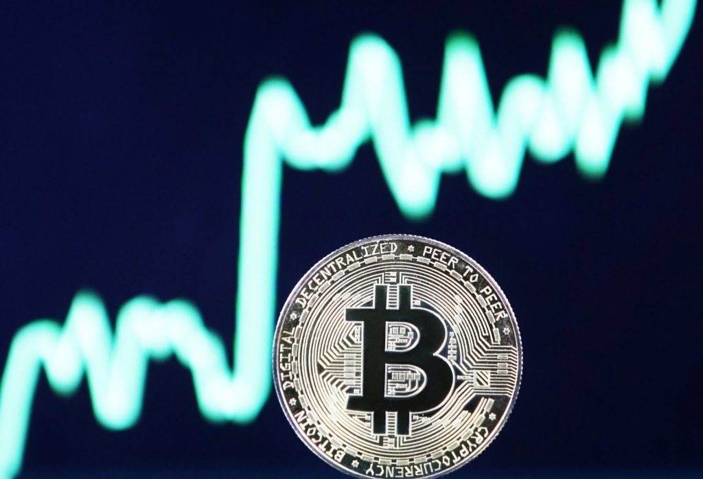 Bitcoin in front of a crypto price chart
